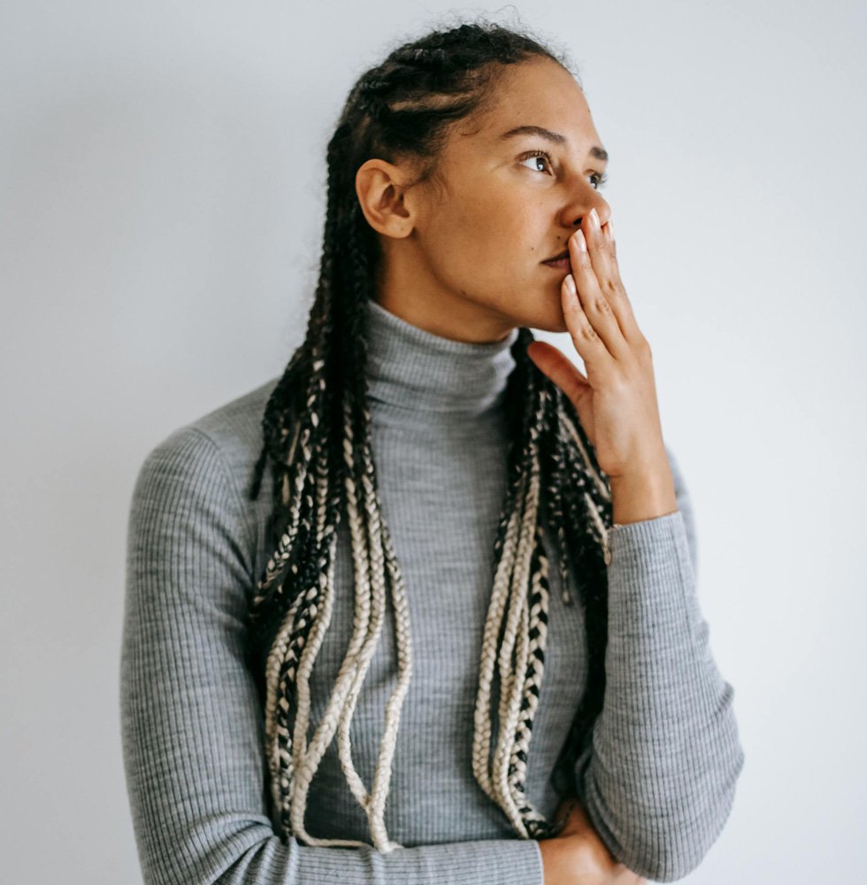 woman standing and thinking about therapy sessions